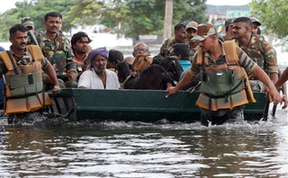 Residents and their goats are rescued by Indian army soldiers from a residential area flooded following heavy rains in Chennai, Tamil Nadu state, India, Tuesday, Nov.17, 2015. Incessant rains that lashed the city since Saturday night flooded several parts of Chennai. (AP Photo/Arun Sankar K)